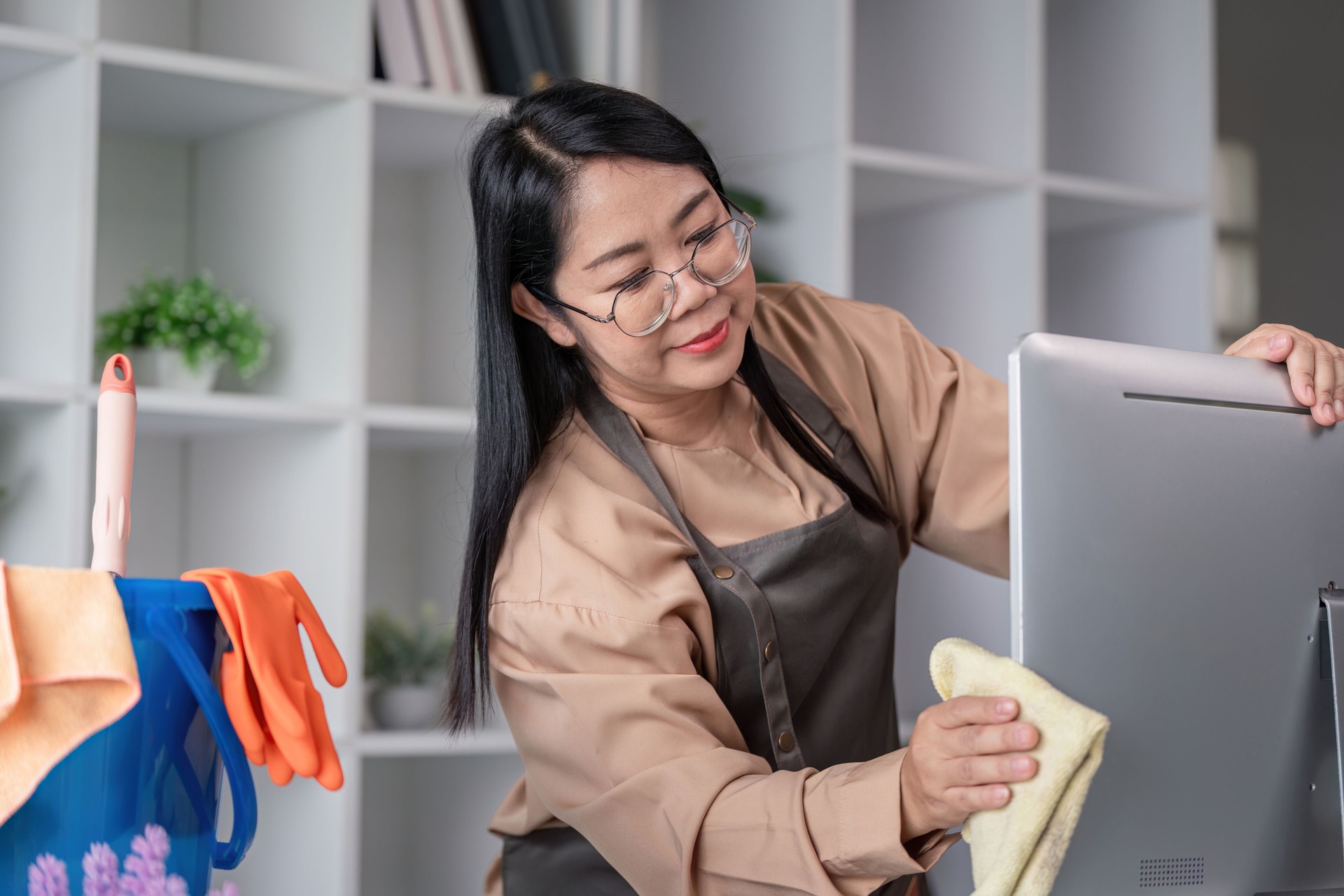 Professional Maid Housekeeper Cleaning a Modern Home Office with Care and Precision
